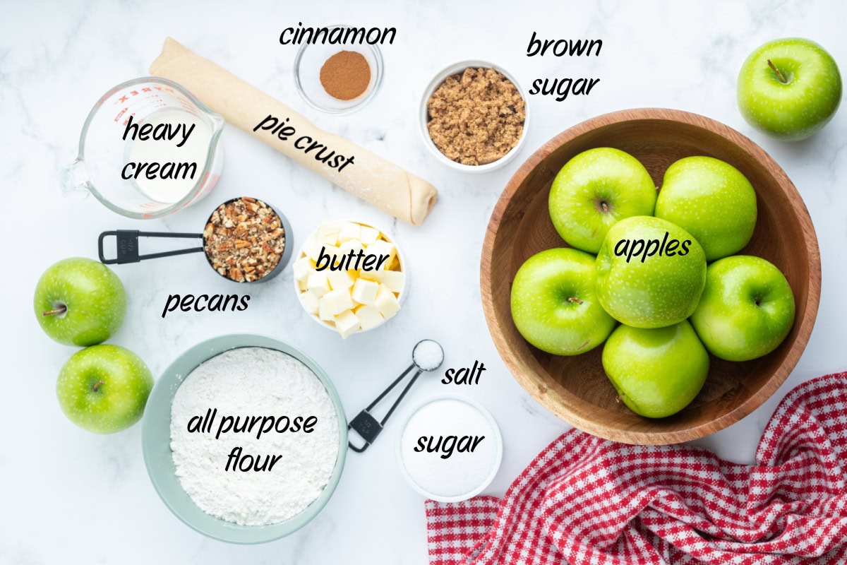 Homemade Dutch Apple Pie with buttery pecan streusel and cinnamon apples. Cozy, classic, and perfect for fall baking or holiday dessert tables. ingredients displayed for making dutch apple pie