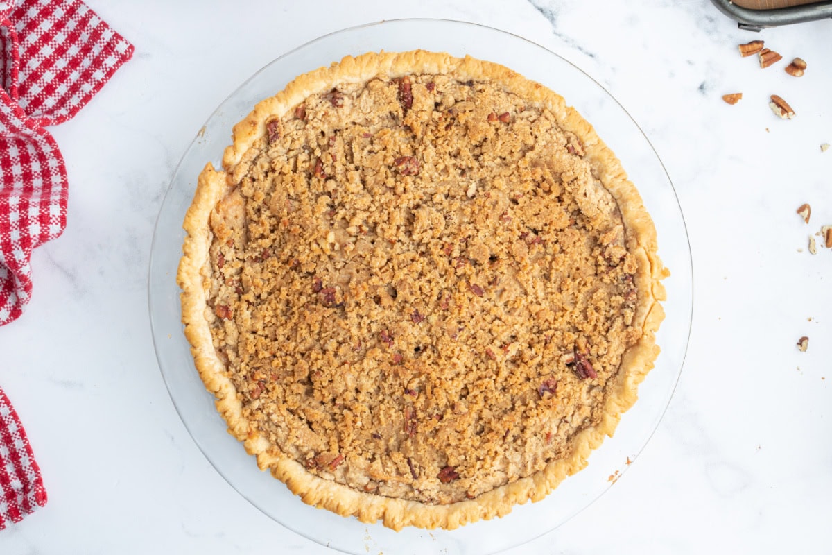 Homemade Dutch Apple Pie with buttery pecan streusel and cinnamon apples. Cozy, classic, and perfect for fall baking or holiday dessert tables. dutch apple pie overhead shot