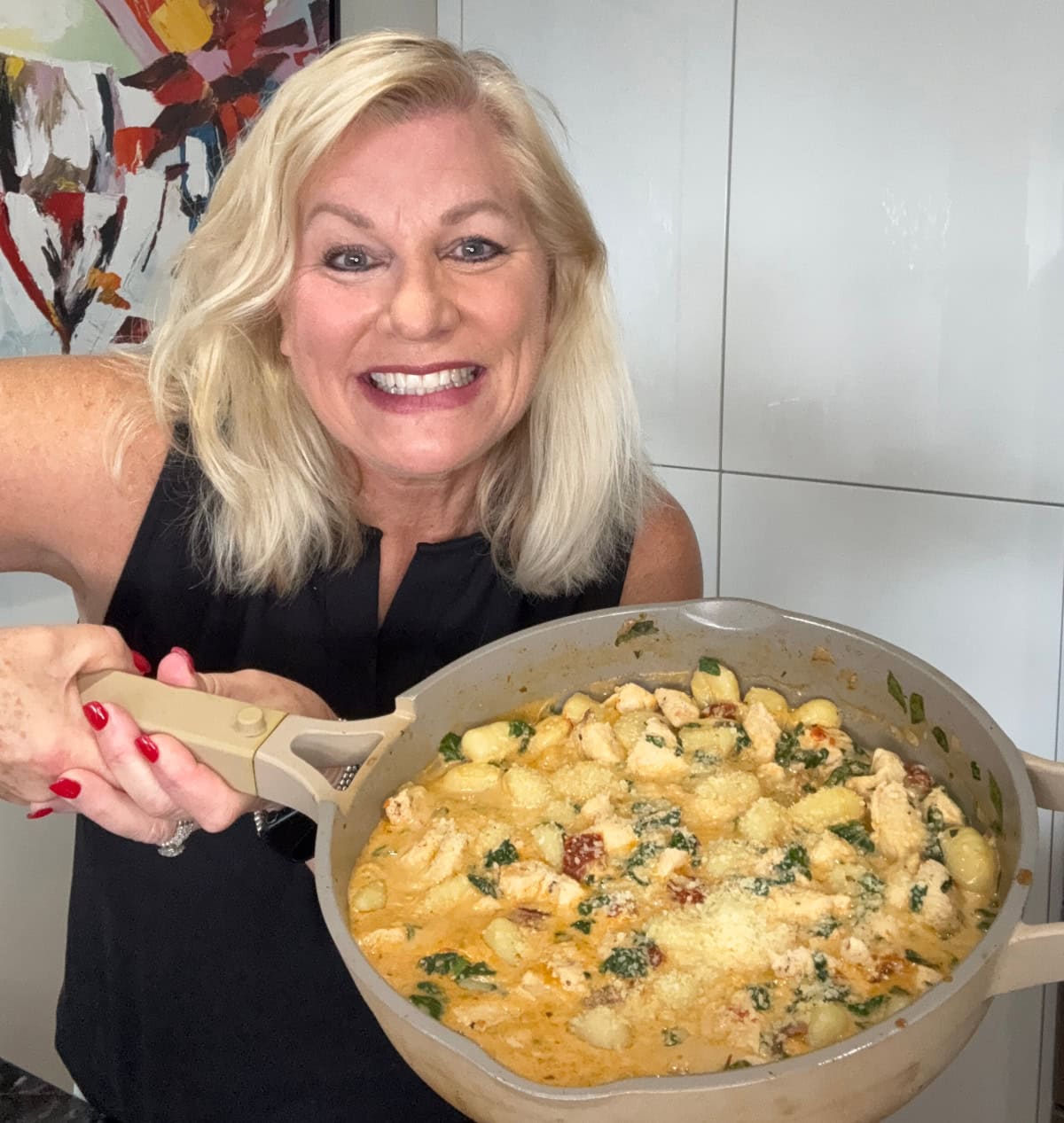 recipegirl holding pan of marry me chicken gnocchi
