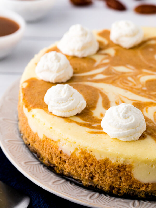pumpkin swirl cheesecake with whipped cream on top