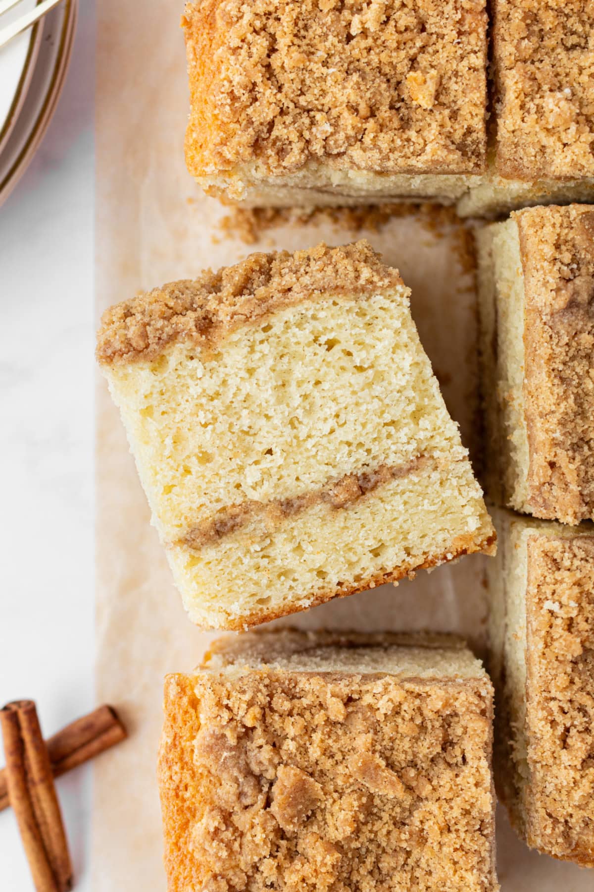 slices of copycat starbucks cinnamon coffee cake with one sitting on its side
