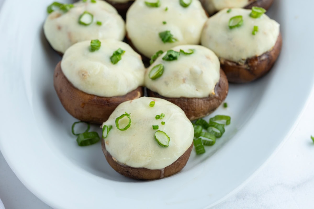 several boursin stuffed mushrooms on a platter