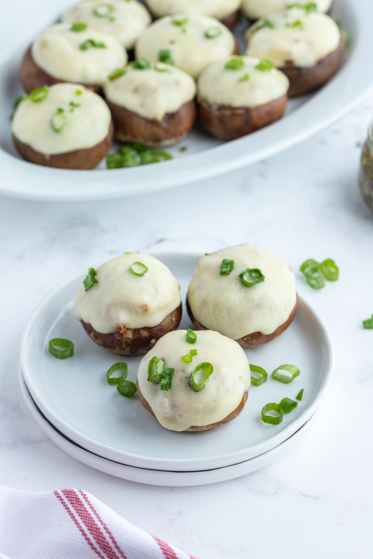 three boursin stuffed mushrooms on a plate