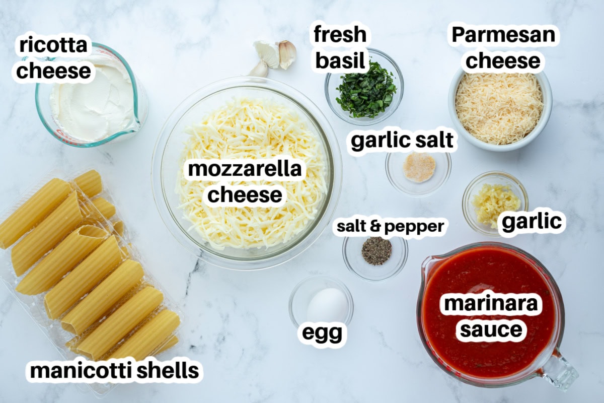 This classic Cheese Manicotti is stuffed with a creamy three-cheese filling, covered in marinara, and baked until bubbly. Easy, comforting, and perfect for family dinners! ingredients displayed for making cheese manicotti