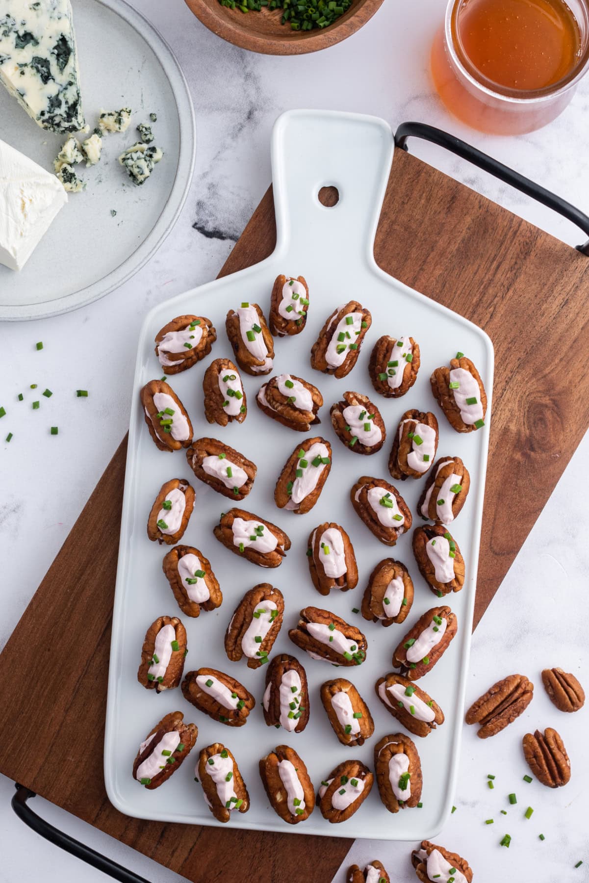 overhead shot of cheesy pecan appetizers on a board
