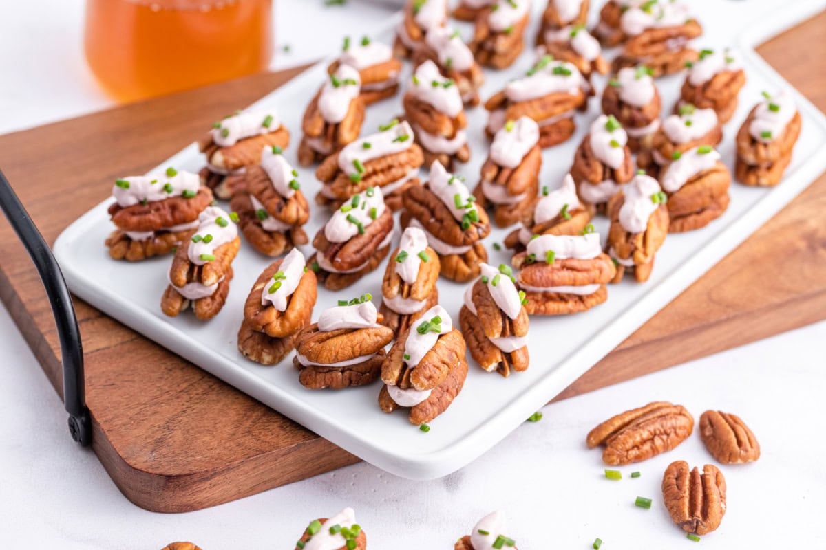 lots of cheesy pecan appetizers on a serving plate