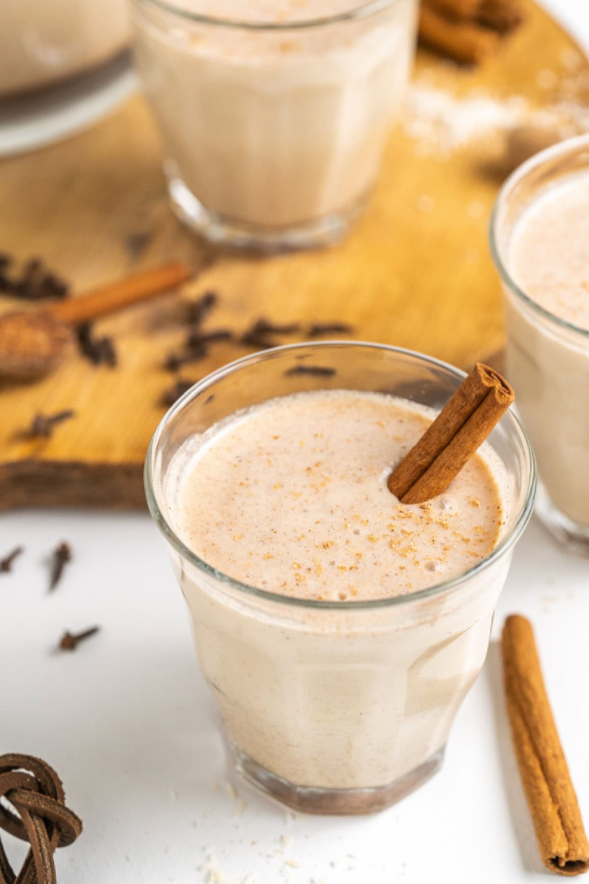 This easy, authentic Puerto Rican Coquito is rich, creamy, spiced, and perfect for Christmas! Made with coconut milk, sweetened condensed milk, and rum — just blend and chill. coquito in a glass with a cinnamon stick