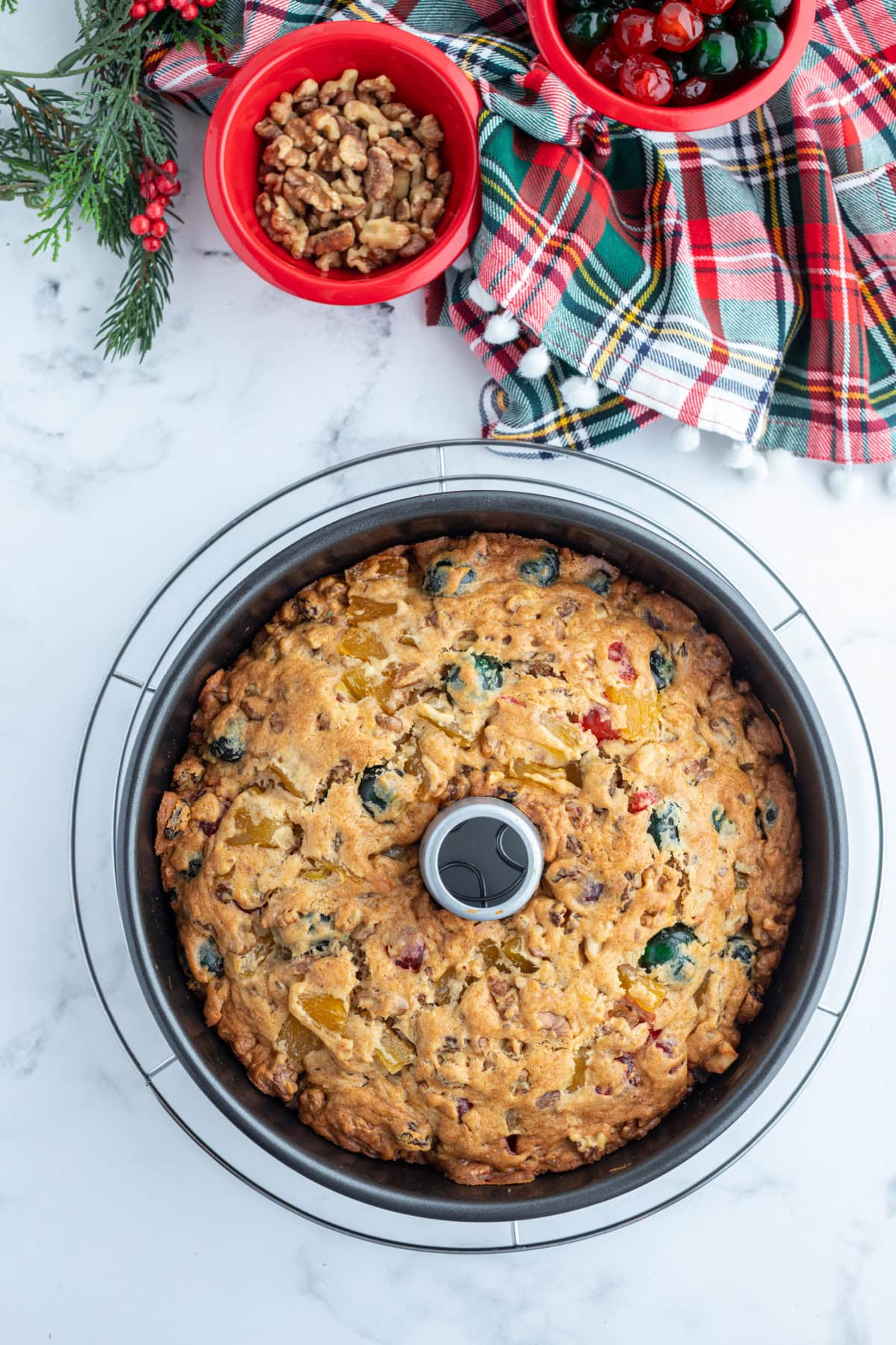 This homemade fruitcake is rich, moist, and loaded with candied fruit and nuts. A traditional Christmas dessert that bakes beautifully and slices perfectly every time. overhead shot of fruitcake made in tube pan