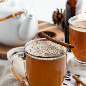 hot buttered rum in a mug with a cinnamon stick garnish