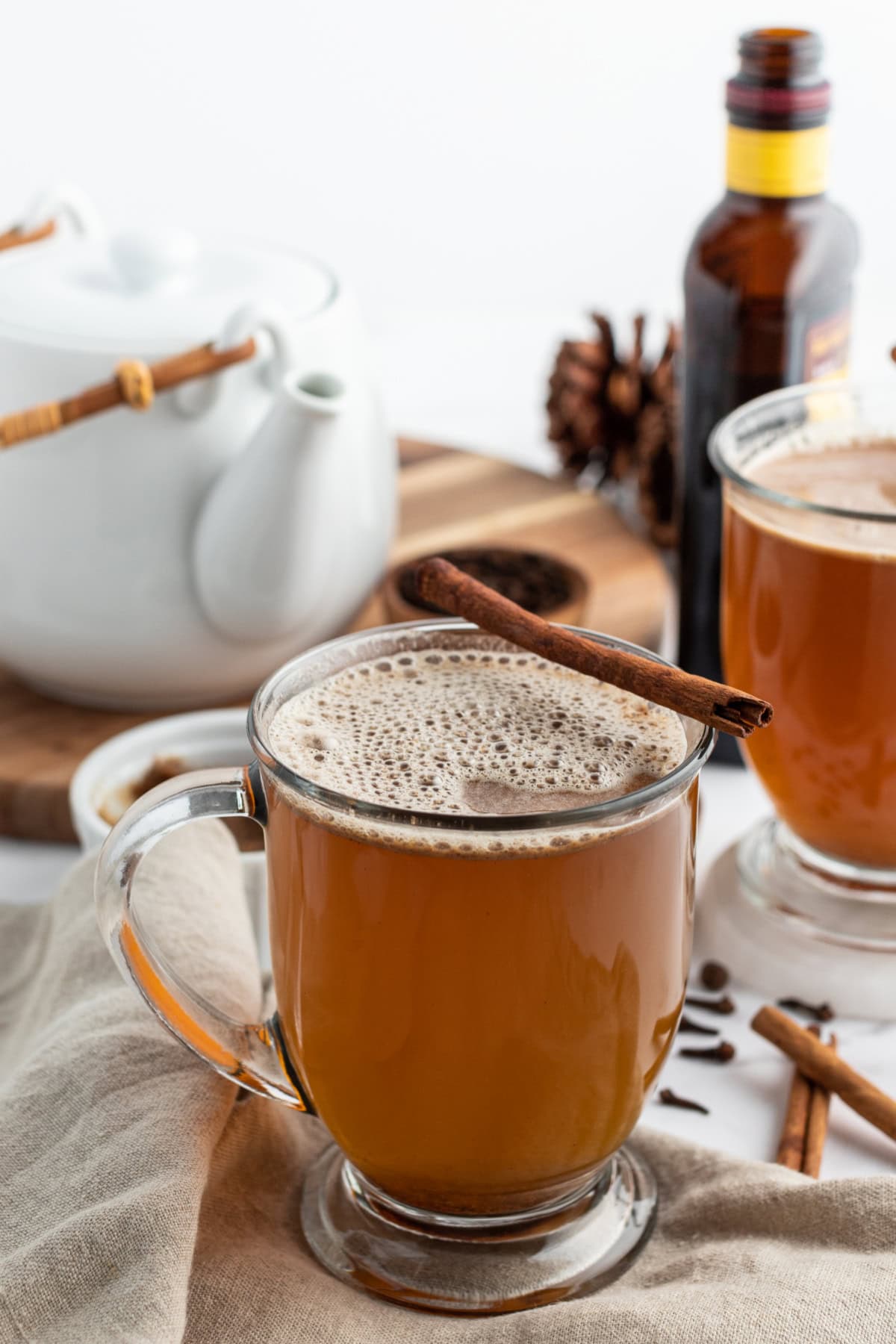 hot buttered rum in a mug with a cinnamon stick garnish