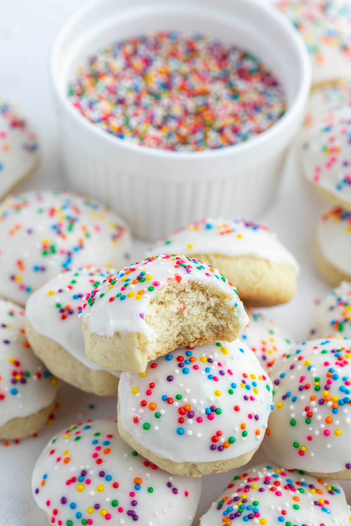 iced italian cookies one with bite taken out of it