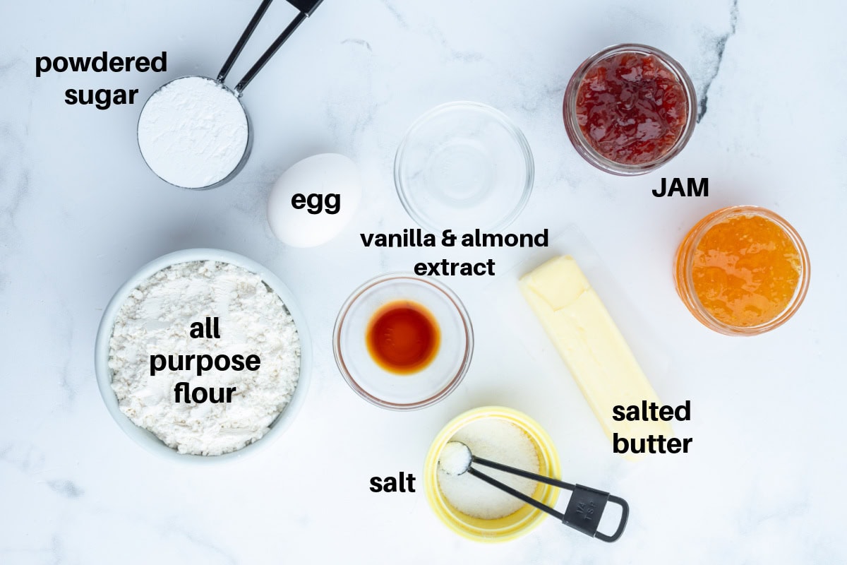 These soft and buttery Jam Thumbprint Cookies are filled with your favorite fruit jam and baked to golden perfection. A classic holiday cookie that’s easy, nostalgic, and perfect for gifting! ingredients displayed for making jam thumbprint cookies