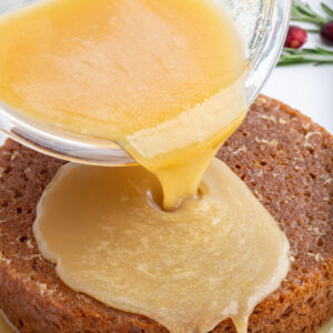 lemon sauce for gingerbread pouring onto gingerbread cake