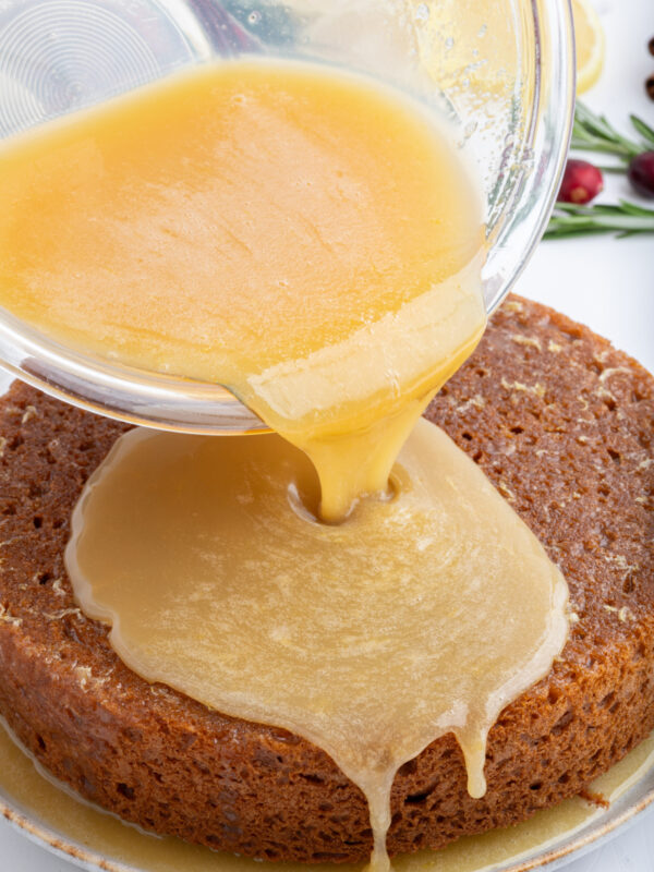 lemon sauce for gingerbread pouring onto gingerbread cake