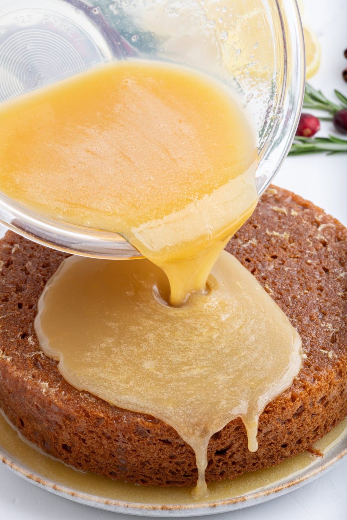 lemon sauce for gingerbread pouring onto gingerbread cake