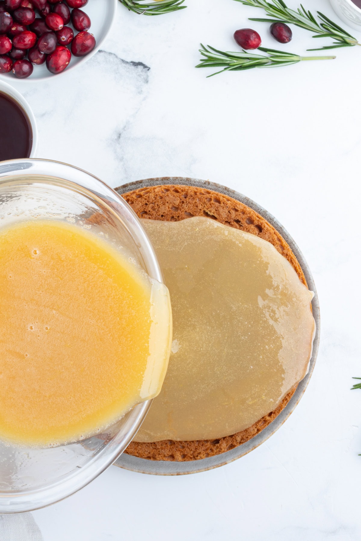 pouring lemon sauce onto gingerbread