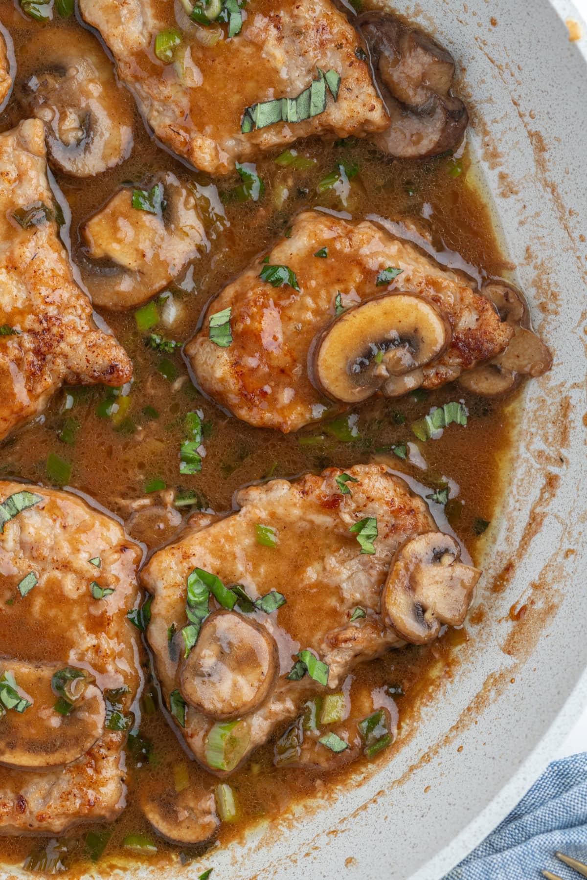 Tender pan-seared veal simmered in a glossy Marsala wine sauce with mushrooms and green onions. This easy Veal Marsala is elegant, flavorful, and perfect for entertaining or weeknight comfort food. half a skillet of veal marsala