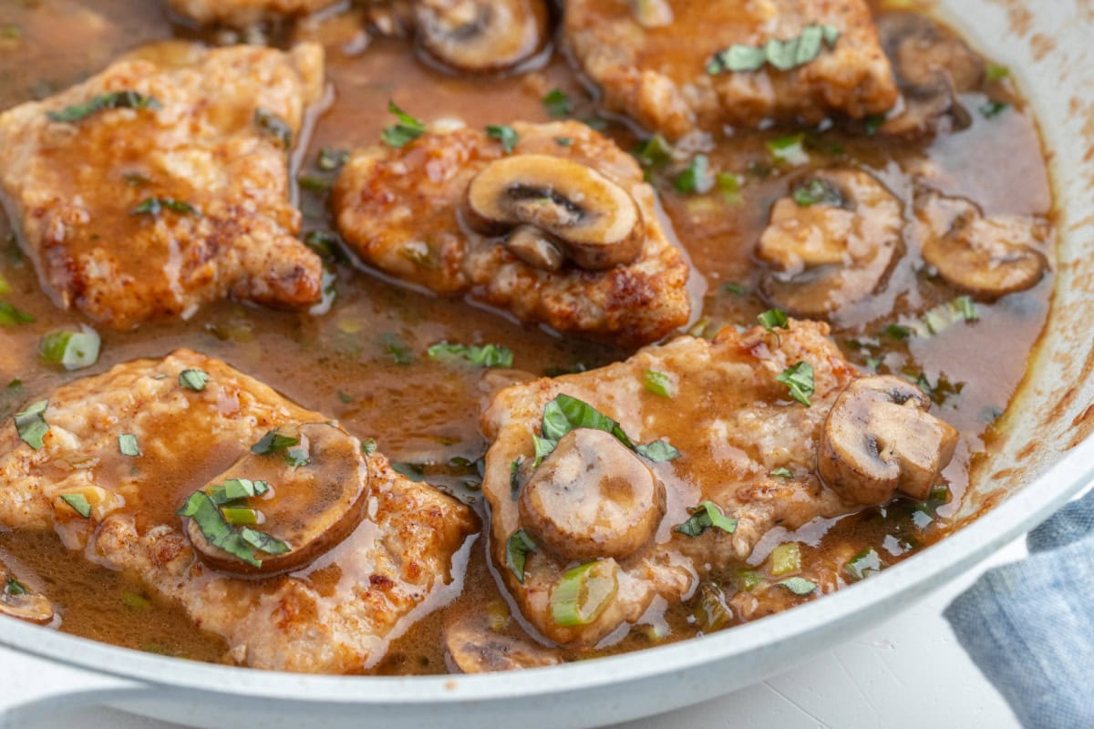 Tender pan-seared veal simmered in a glossy Marsala wine sauce with mushrooms and green onions. This easy Veal Marsala is elegant, flavorful, and perfect for entertaining or weeknight comfort food. skillet full of veal marsala
