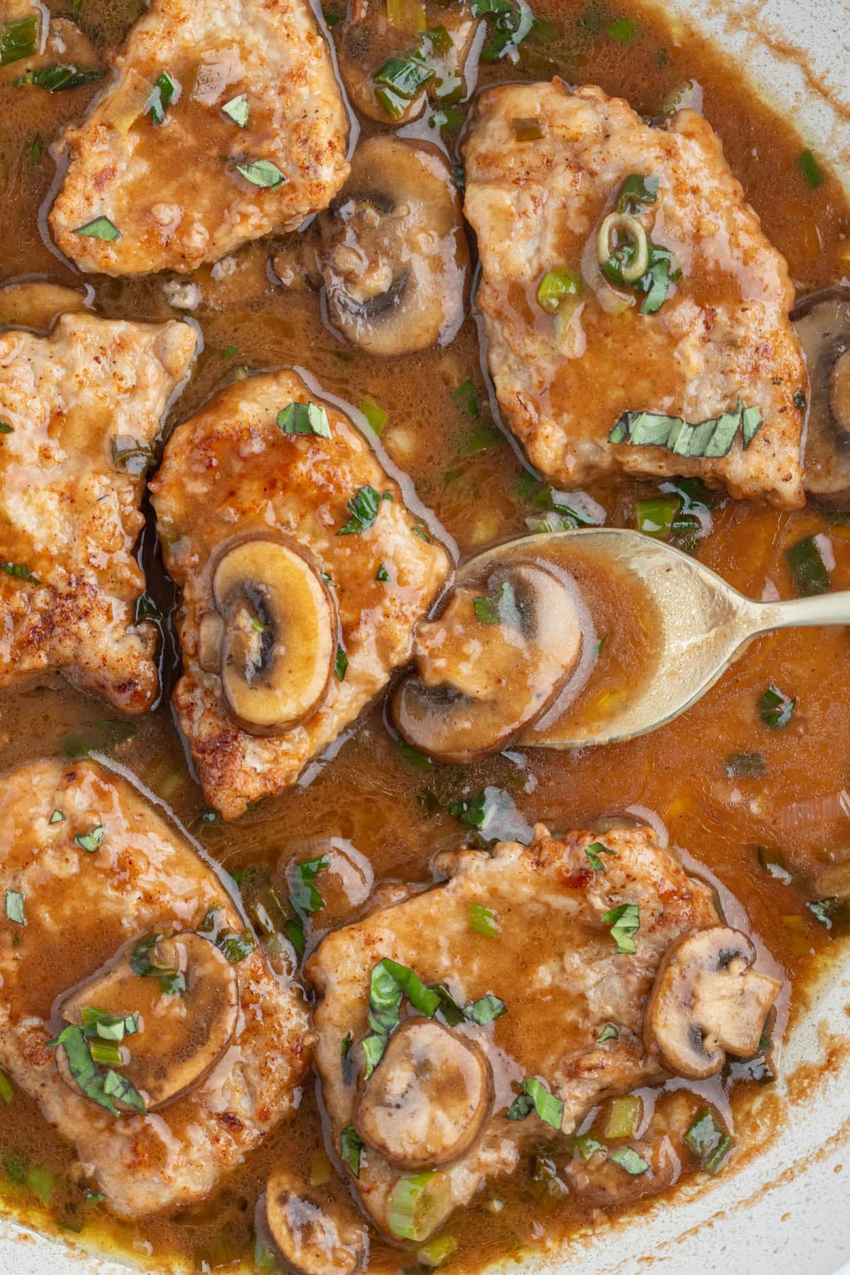 Tender pan-seared veal simmered in a glossy Marsala wine sauce with mushrooms and green onions. This easy Veal Marsala is elegant, flavorful, and perfect for entertaining or weeknight comfort food. spoon in skillet of veal marsala