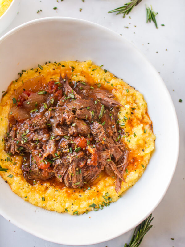 slow cooker italian pot roast in bowl served over polenta