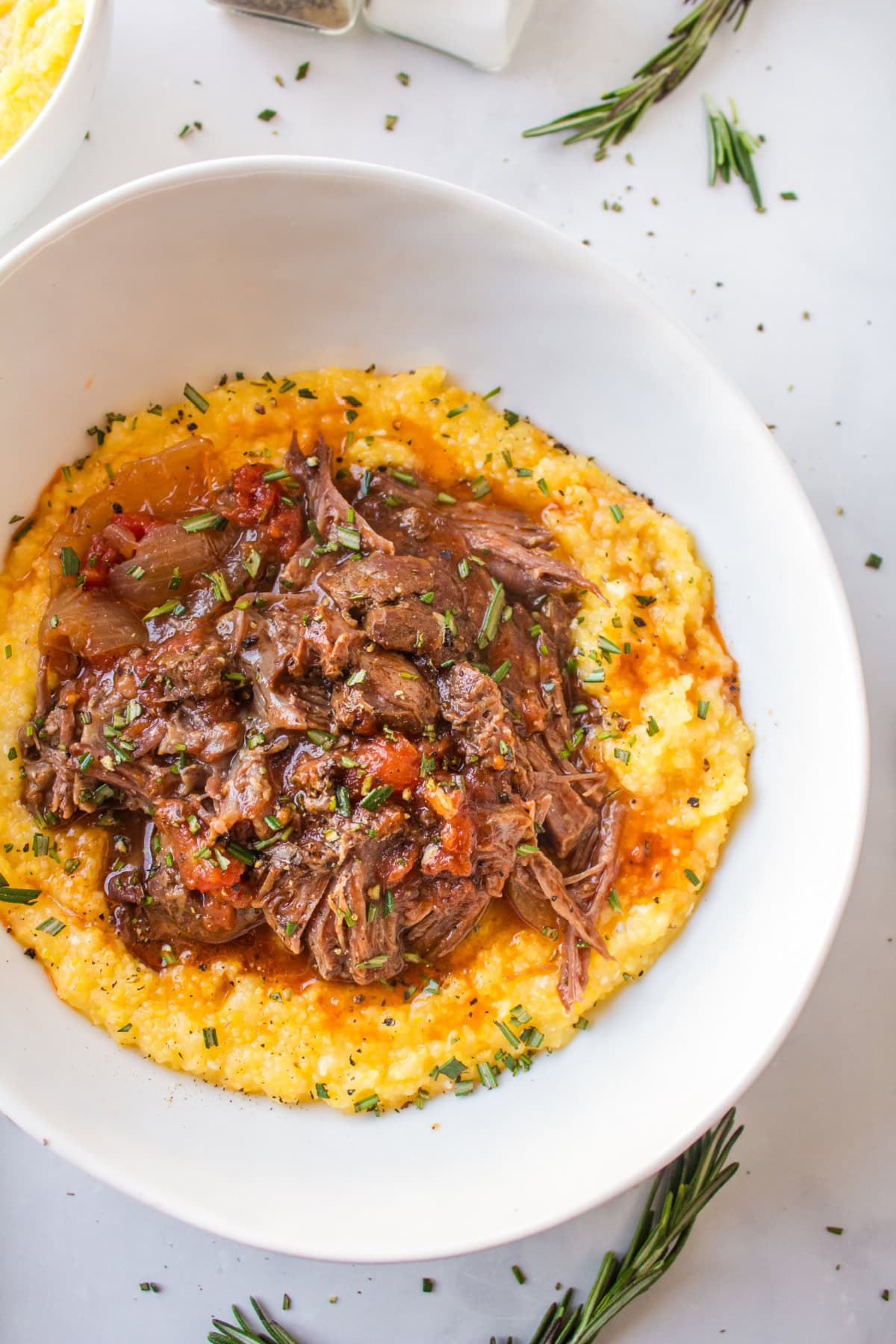 slow cooker italian pot roast in bowl served over polenta
