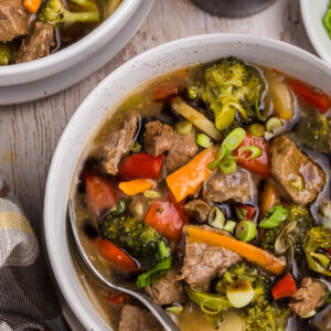 white bowls of beef and vegetable stew