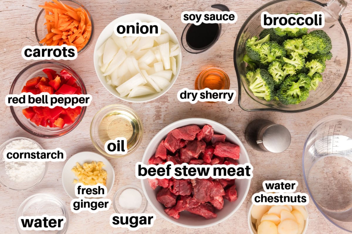 This Beef and Vegetable Stew is comfort food with a twist! Tender beef simmers in a savory soy-ginger broth with carrots, broccoli, red bell pepper, and water chestnuts. Perfect for cool nights and great for leftovers! ingredients displayed for making beef and vegetable stew