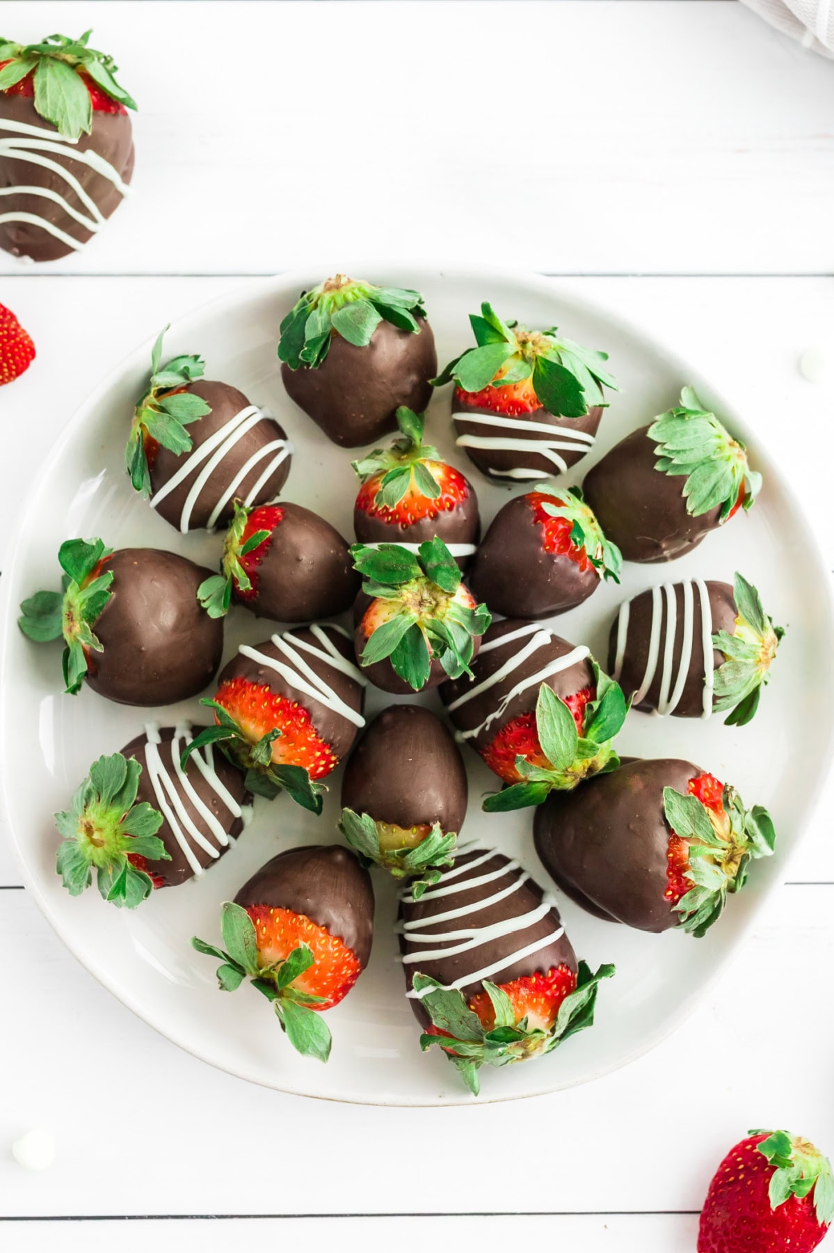 overhead shot of chocolate covered strawberries on a plate