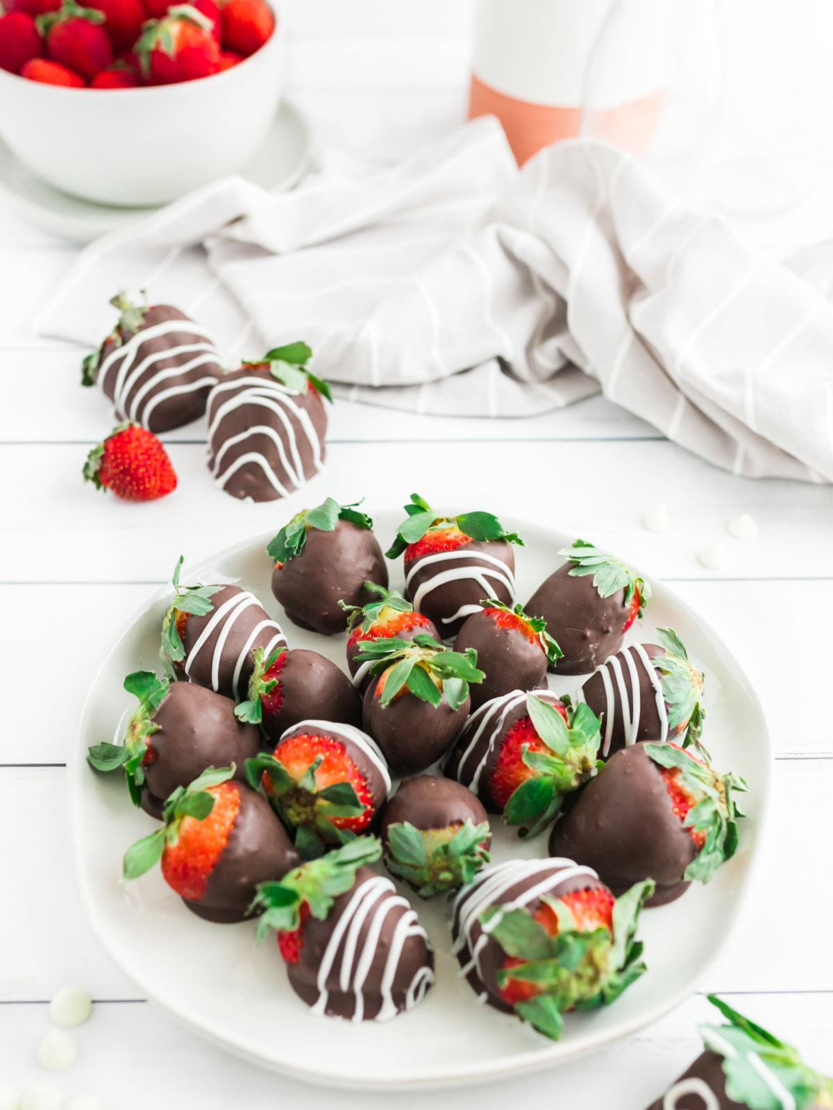 several chocolate covered strawberries on a plate