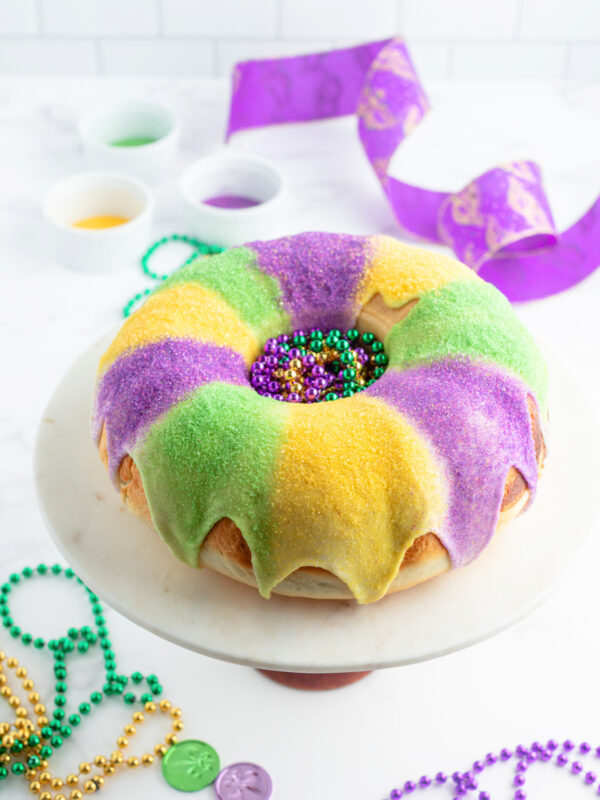 decorated king cake for mardi gras on a cake platter