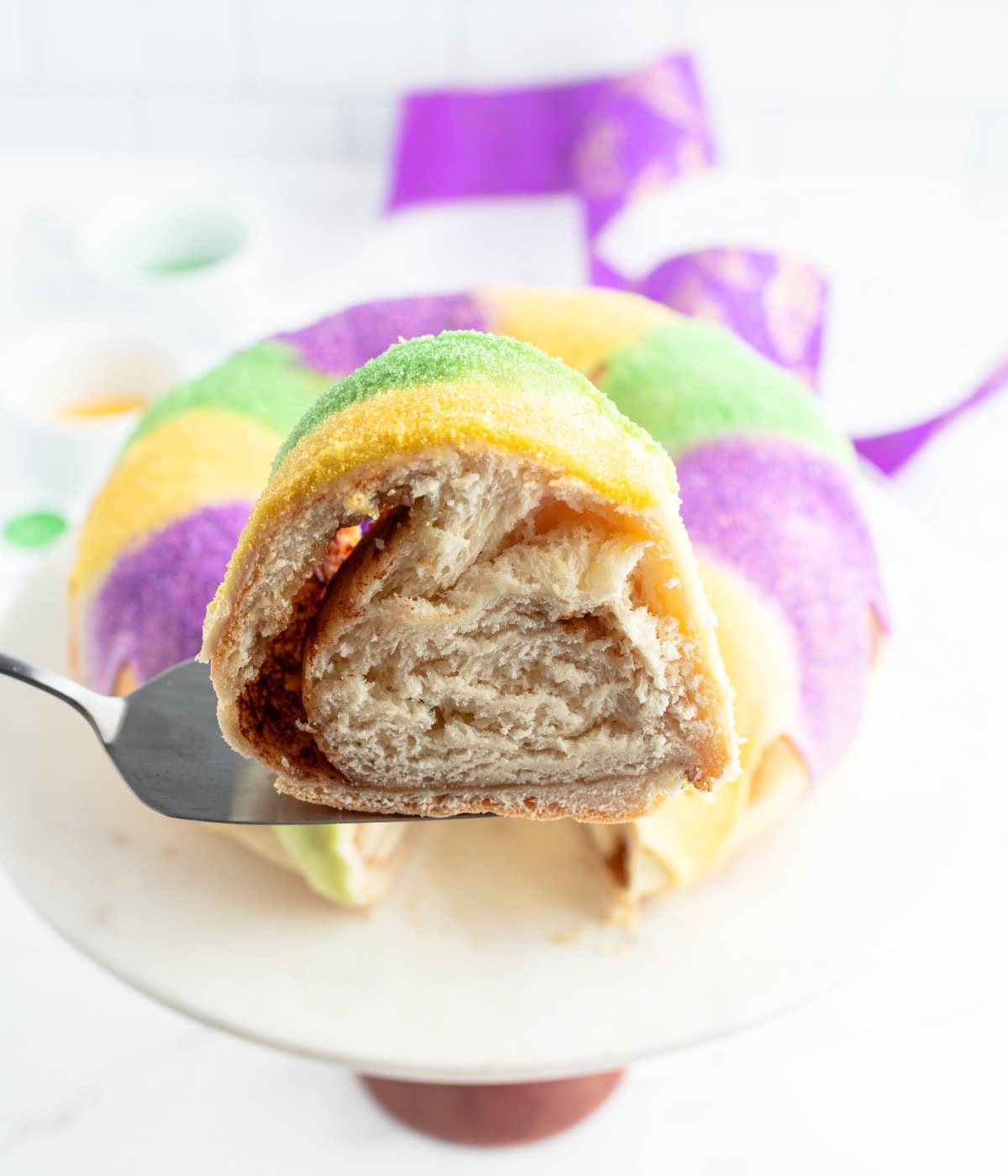 spatula holding up slice of king cake