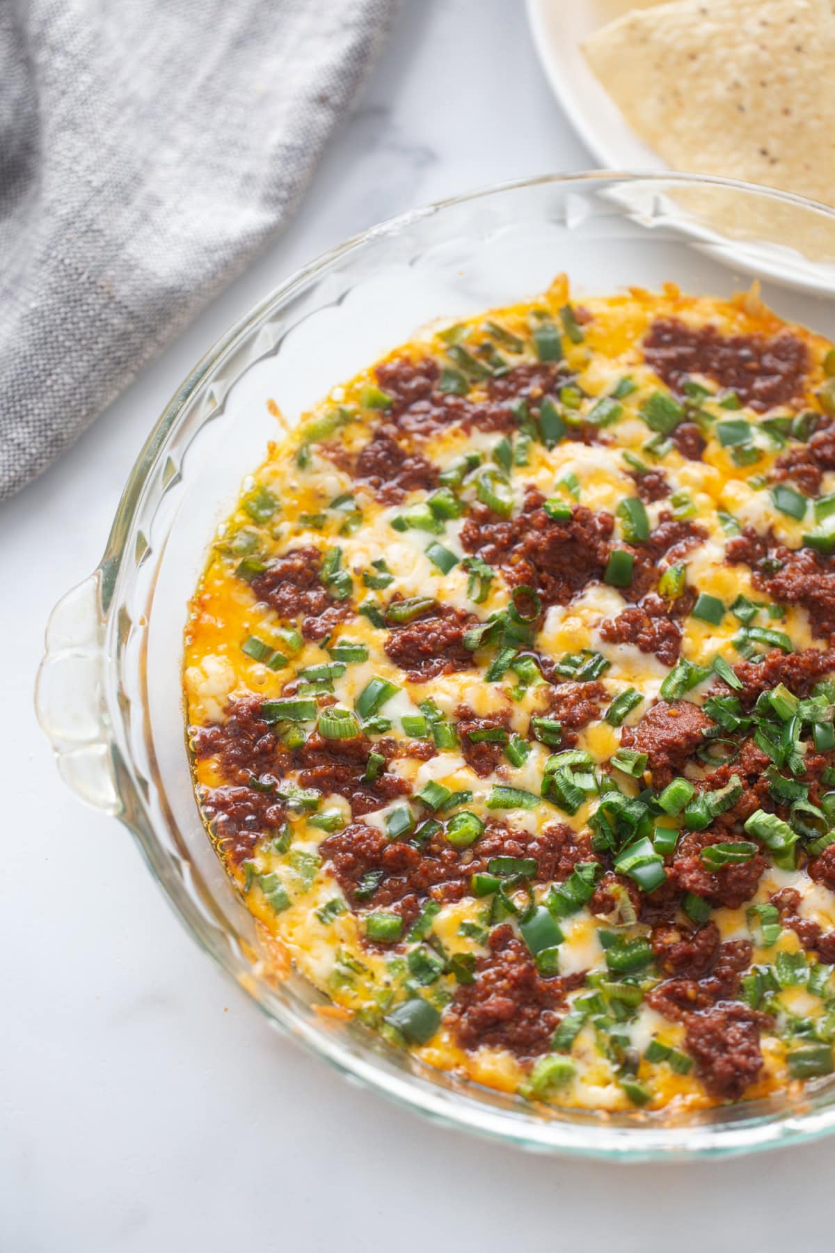 Queso Fundido Recipe 🧀🔥 Classic hot melted cheese dip baked with chorizo, jalapeños, and green onions. Ready in 30 minutes and perfect for parties, taco night, and game day! queso fundido recipe made in glass pie pan