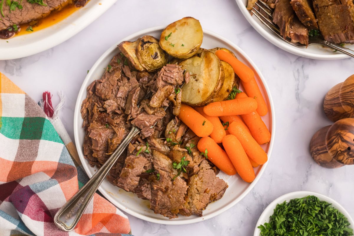 rabbi's wife's brisket serving on plate with carrot and potato