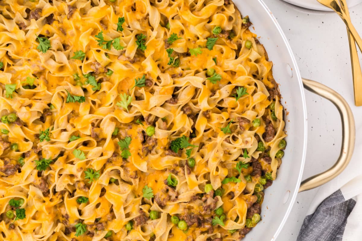 This Ground Beef Stroganoff is creamy, cheesy, and loaded with beef and noodles in a rich sauce. A cozy, easy dinner idea! pan of ground beef stroganoff
