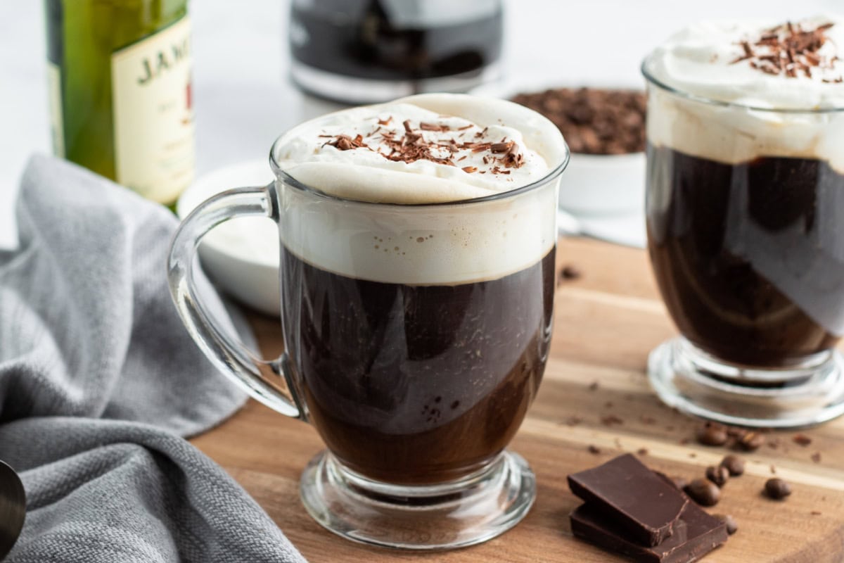 Learn how to make Irish Coffee—hot coffee, Irish whiskey, brown sugar, and whipped cream. A cozy classic cocktail. Irish Coffee