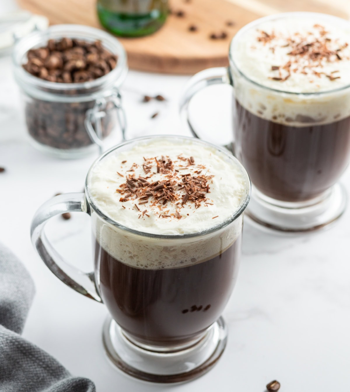 Learn how to make Irish Coffee—hot coffee, Irish whiskey, brown sugar, and whipped cream. A cozy classic cocktail. irish coffee in mugs