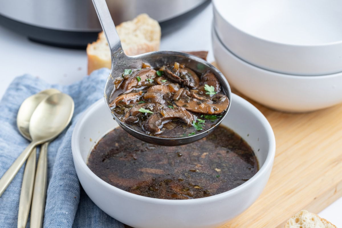ladle full of wild mushroom soup