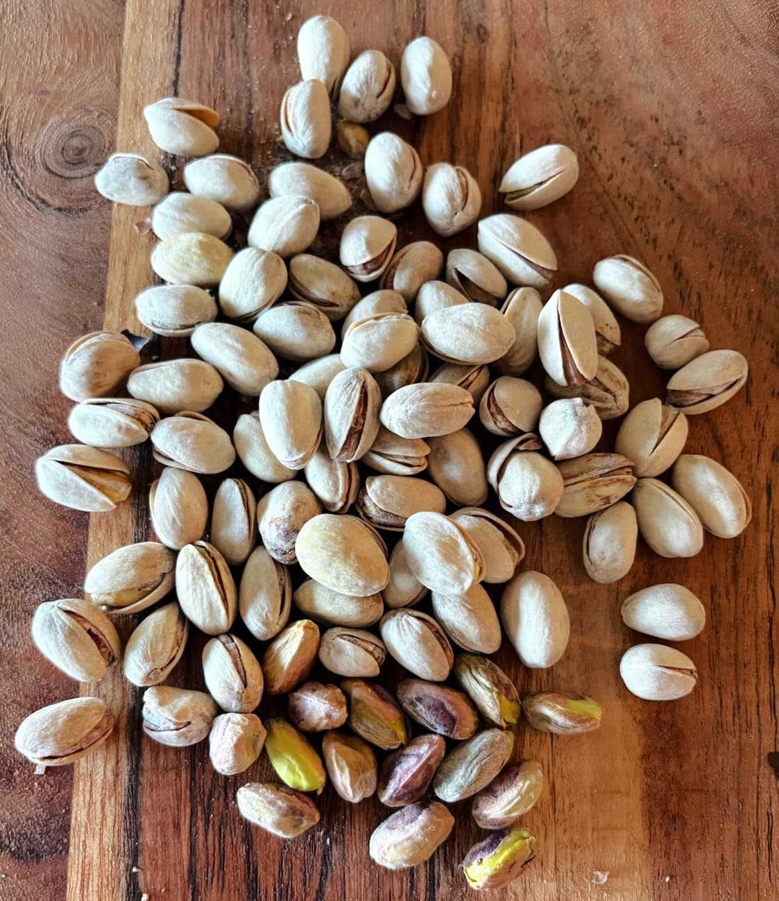 Several pistachios on a board