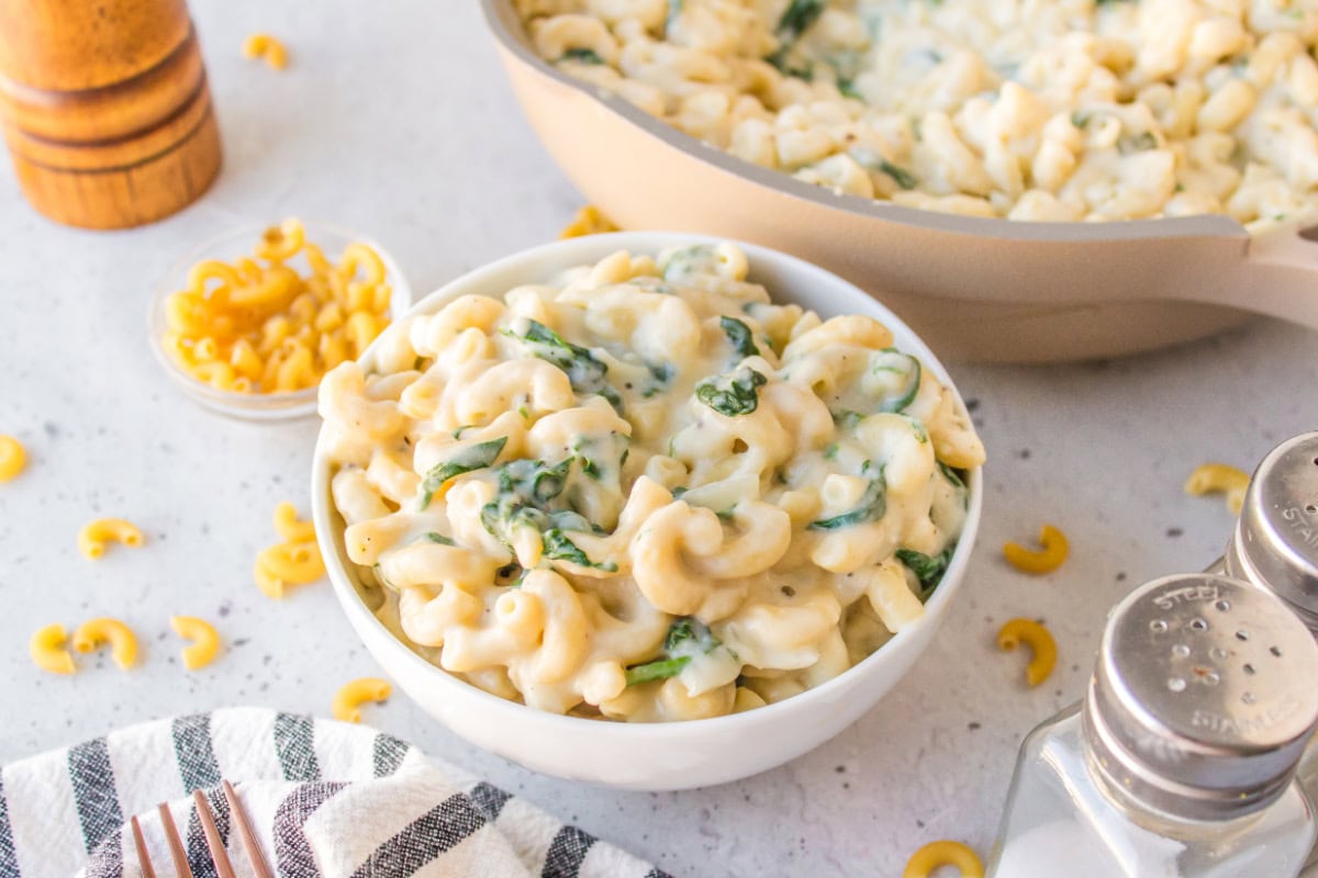 Spinach Mac and Cheese is creamy, cheesy comfort food with fresh spinach and a blend of delicious cheeses. bowl of spinach mac and cheese