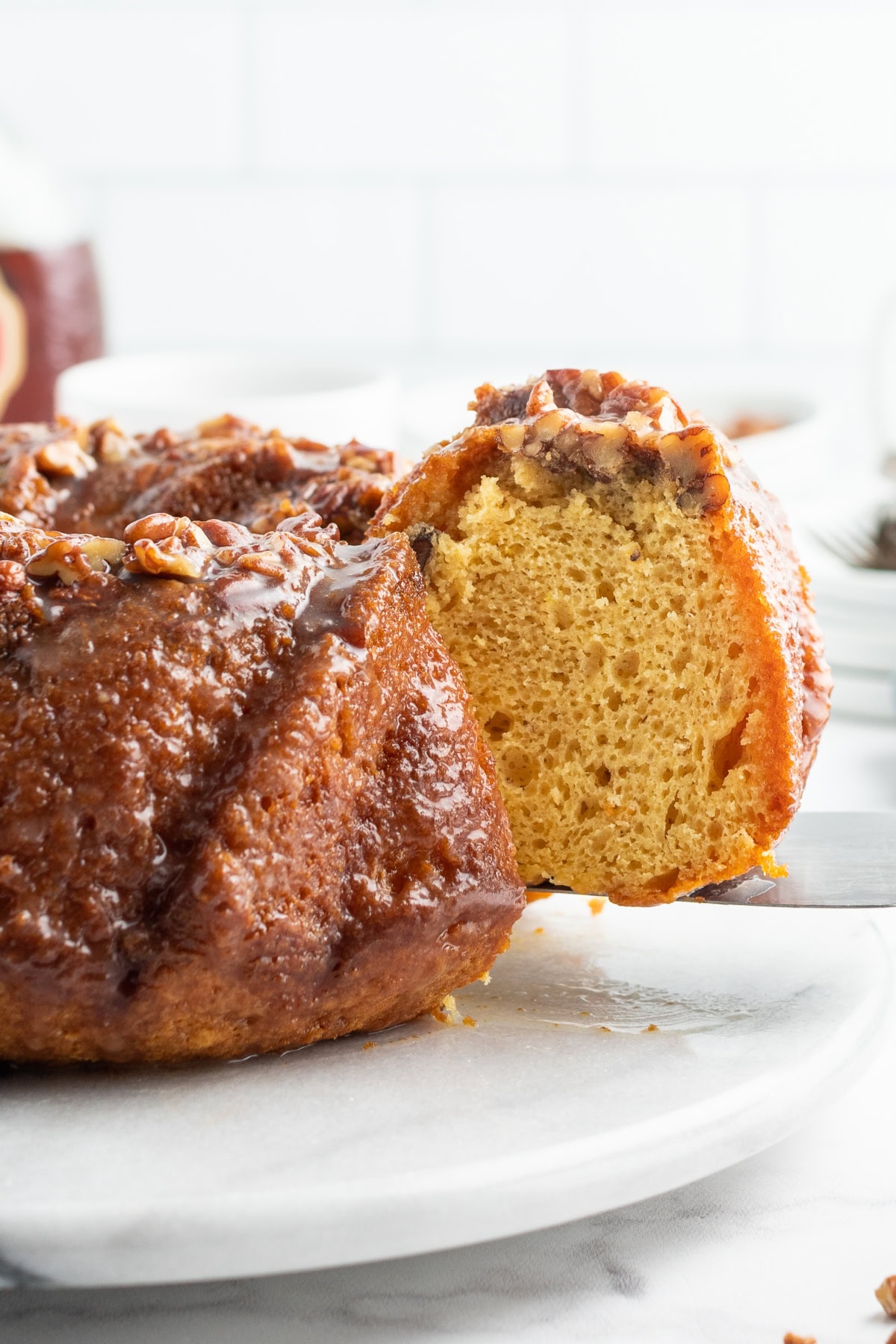 spatula taking out slice of cake from bundt