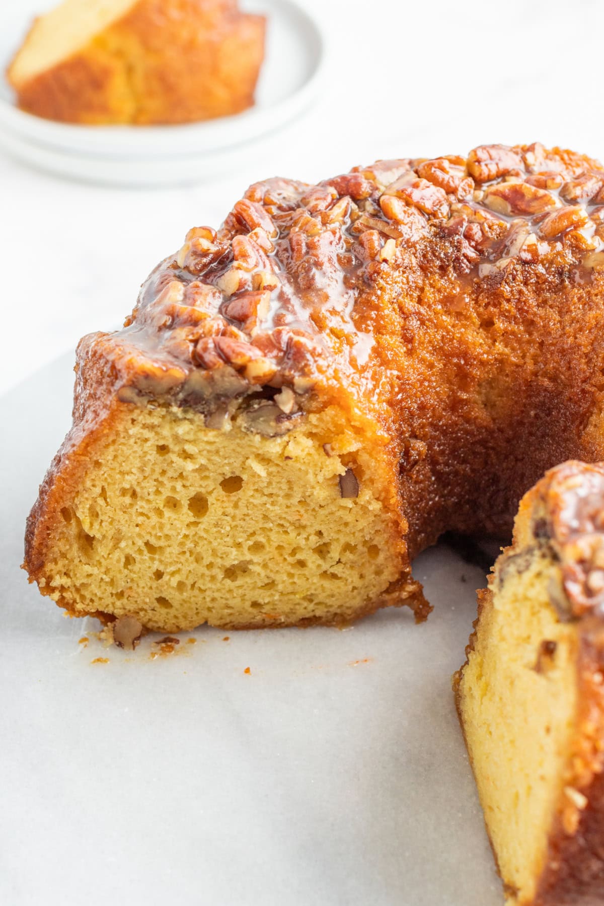 amaretto bundt cake with large slice taken out of it