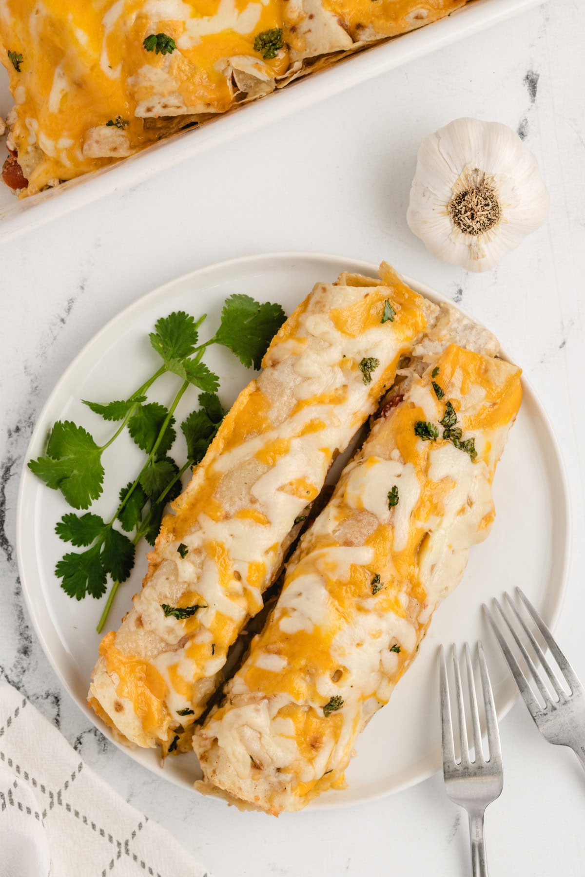 serving of cheesy chicken enchiladas on plate