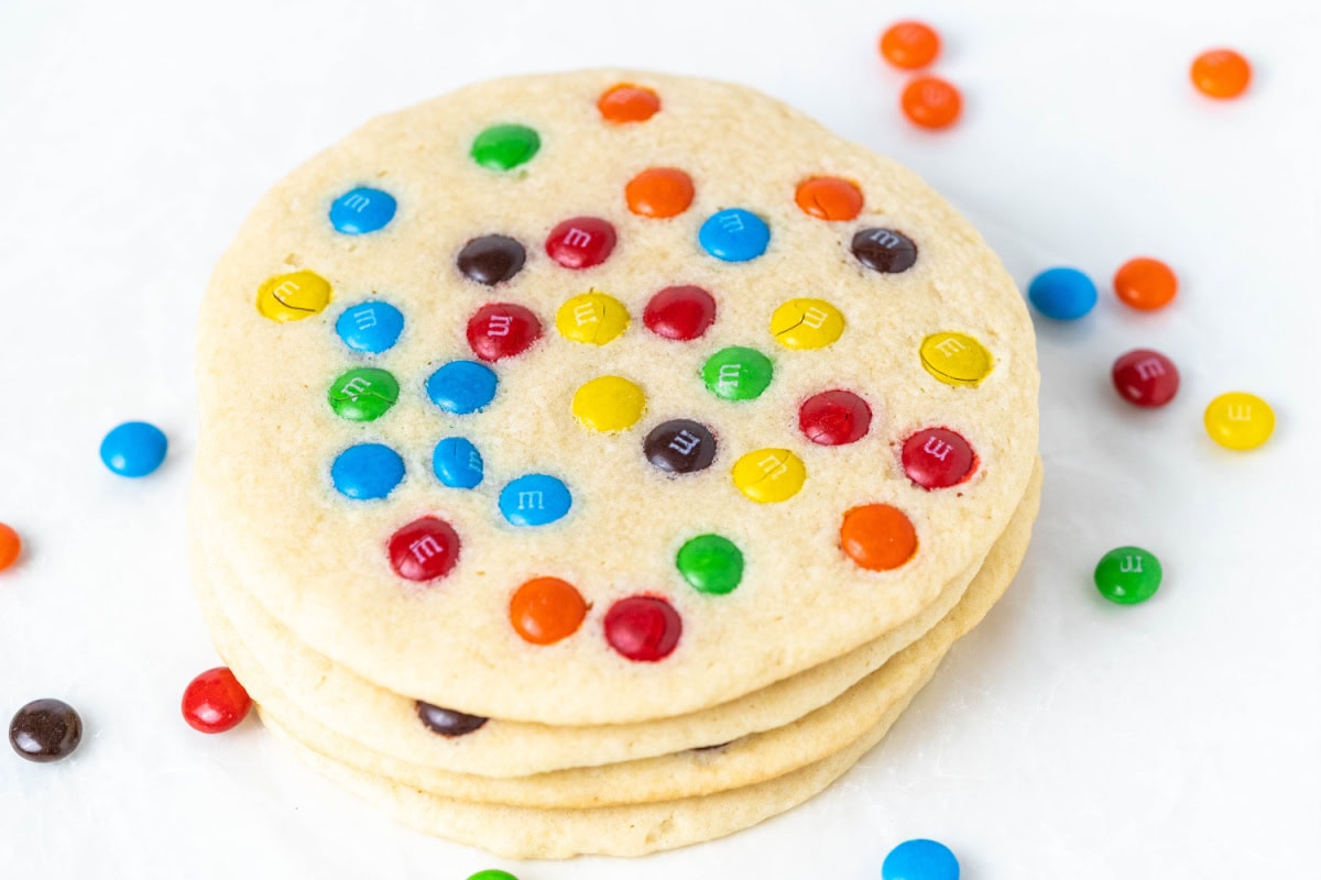 Giant M&M Cookies are soft, chewy and loaded with candy. A bakery-style cookie recipe you can easily make at home. stack of giant m&m cookies
