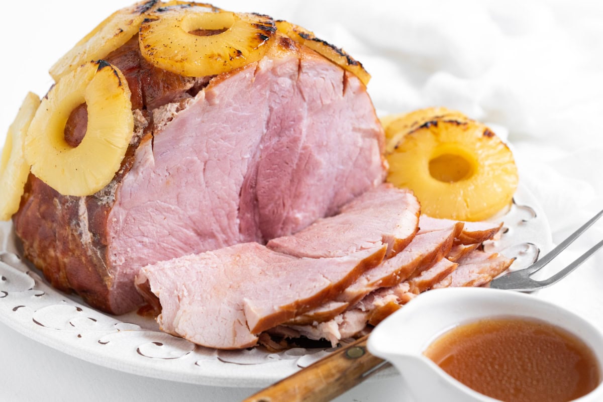 baked ham sliced open with pineapple on top