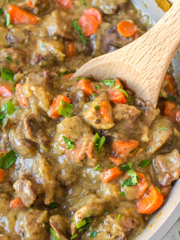 pork meat stew with wooden spoon