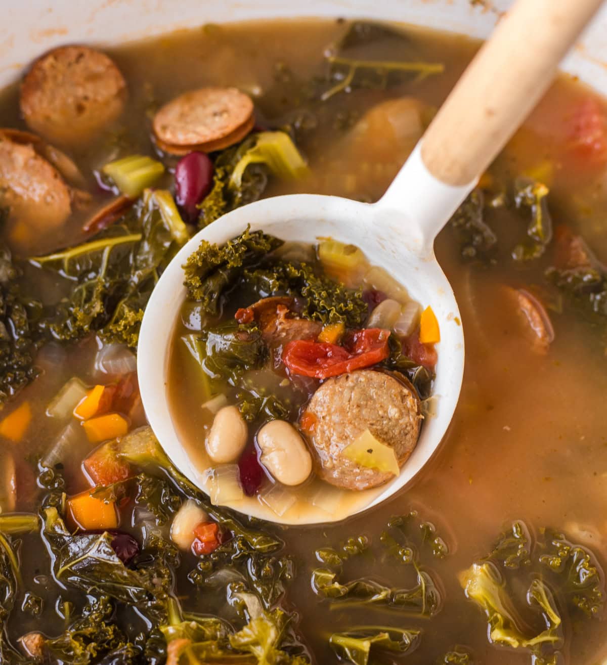 ladle full of tuscan sausage soup