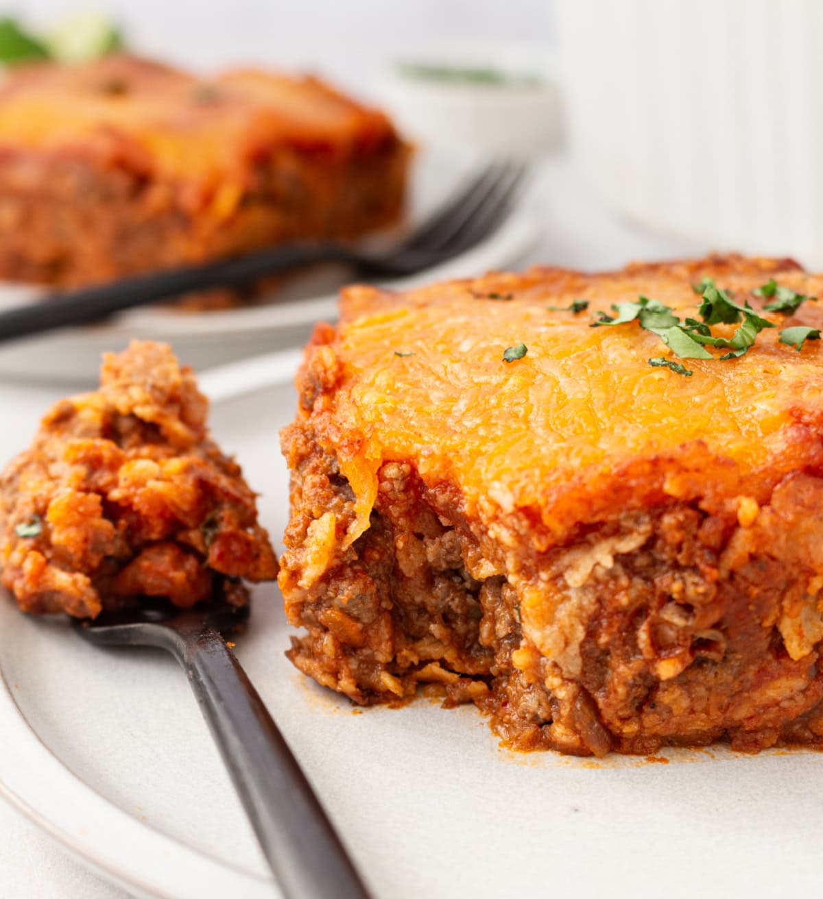 beef enchilada bake om plate with fork full of food