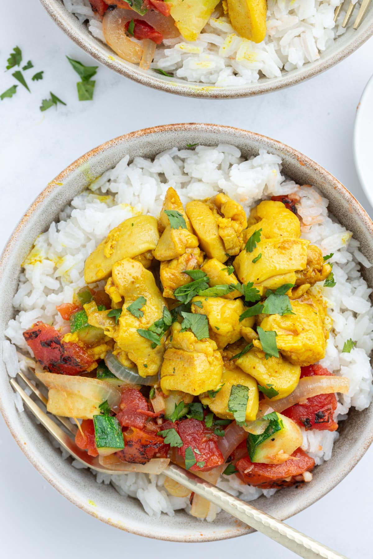 overhead shot of chicken curry bowls
