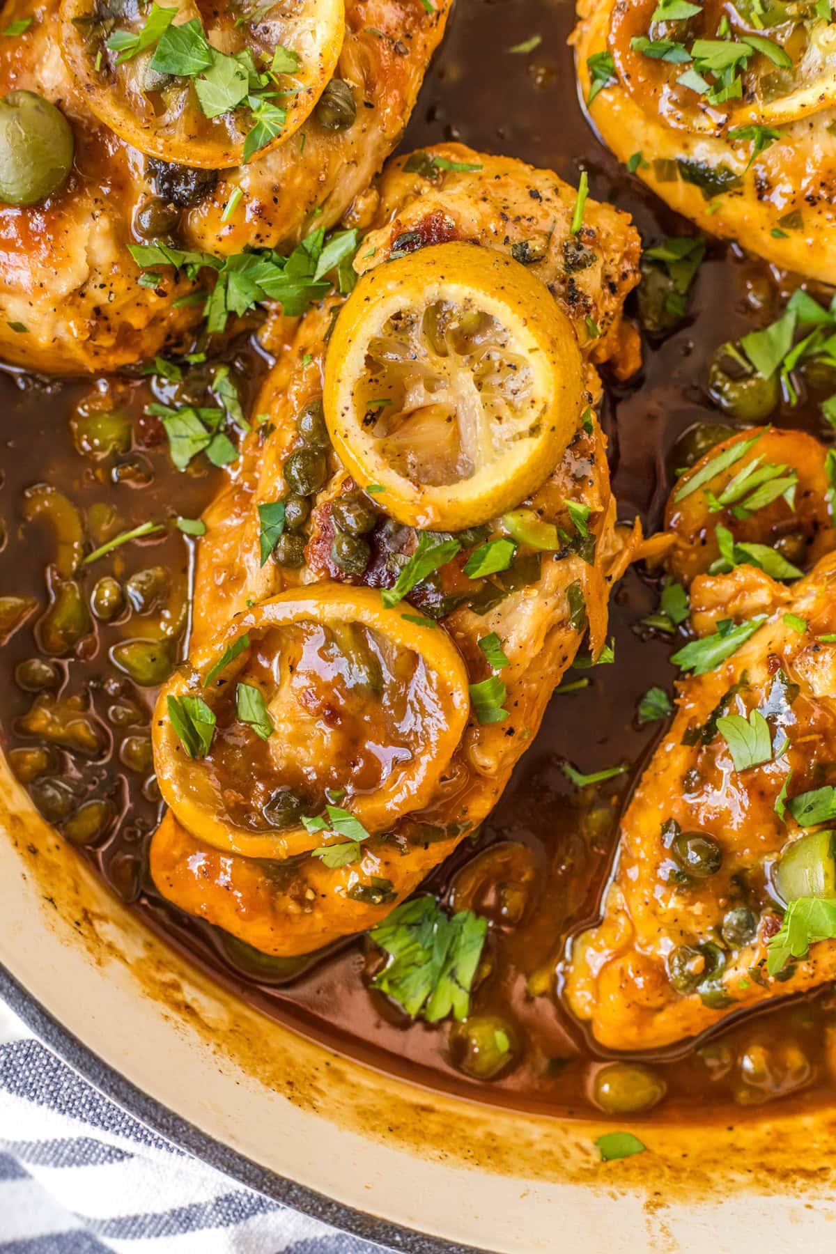 close up chicken with roasted lemons in skillet