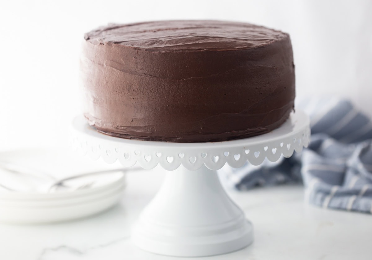Chocolate Mayonnaise Cake is rich, moist and incredibly easy to make. The secret ingredient makes this cake unbelievably soft and delicious. chocolate cake on a cake stand